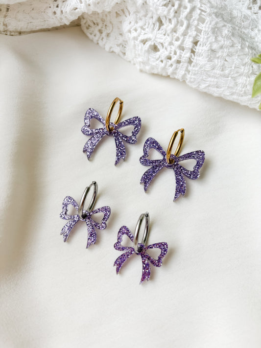 Rusetti korvakorut, violetti glitter